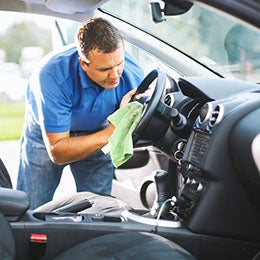 man cleaning car