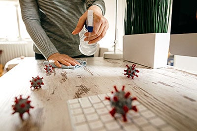 person cleaning desk